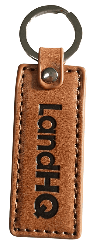 Light brown custom leather keyring with a stamped logo and black colour infill. These are for a farming equipment company.