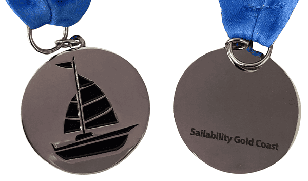 Custom made medal with a nickel plated silver finish. There is a picture of a boat on the front, laser engraving of the organisation name on the back and a blue ribbon for hanging around your neck.