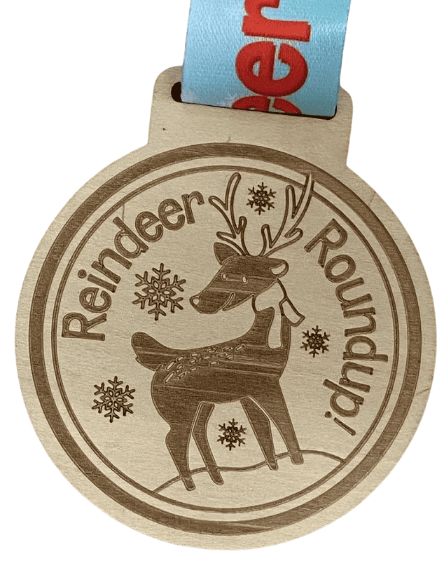Custom wooden medal featuring a reindeer in the middle and debossed logo. 