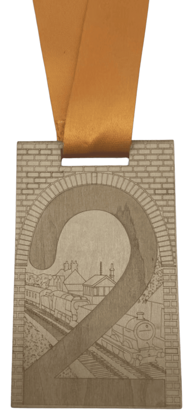 Rectangular customised wooden medal. This features an engraved logo and image of a train going under a bridge and larger number 2. 