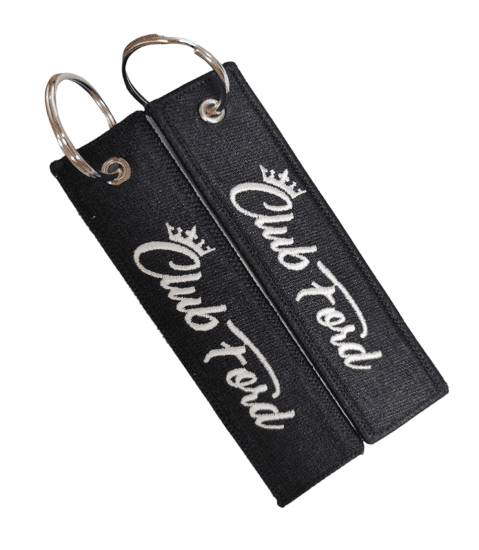 Black custom embroidered keyring with a white stitched logo for a car enthusiast club.