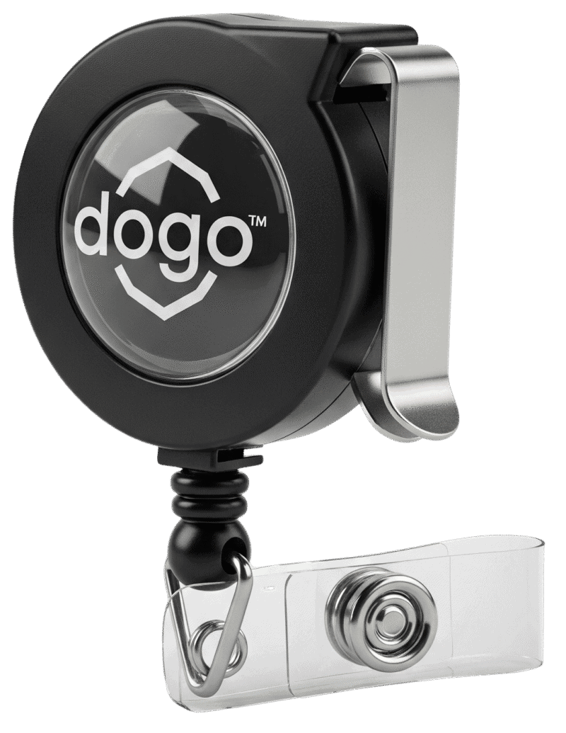 A professional studio photograph of a black retractable badge reel, showing the clear domed logo area and the secure belt clip on the back.