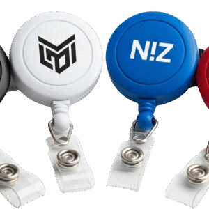 A collection of four custom retractable badge reels in different colours (black, white, blue, and red), each with a unique logo, showcasing the available variety.