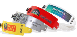 Showcase of custom printed event wristbands: 'Wild Life' yellow, 'Heritage' silver with QR code, 'Northcamp' red, and 'Electronic Festival' design. Perfect for secure festivals & events with custom branding, QR codes, and serial numbers. Enquire for your unique event passes & quote!