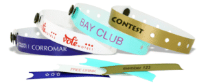 Custom plastic wristbands for hotels (e.g., 'Corromar', 'Olé Hotels'), clubs ('Bay Club'), contests, with tear-off stubs like 'Free Drink' & 'member 123'. Perfect for secure guest ID, promotions & VIP access. Enquire for your design & quote!