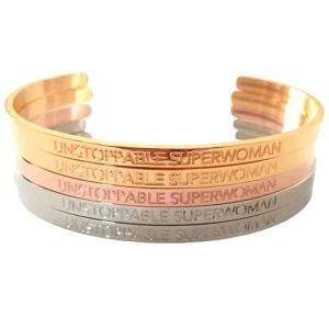 hree custom stainless steel bracelets with an engraved logo, shown in silver, gold, and bronze finishes.