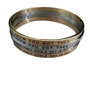 Two custom stainless steel bracelets, one silver and one bronze, with a black laser engraved logo.