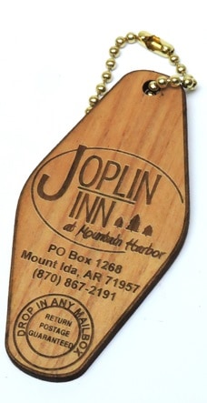 Classic tourism style custom wooden keyring with destination details engraved into the wood.