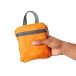 Folden view of an orange lighweight foldable backpack.