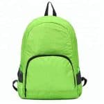 Front view of a green lightweight foldable backpack.