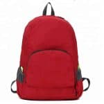 Front view of a red lightweight foldable backpack.