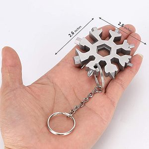 Picture of an 18 in 1 metal multi-tool keyring held int he palm of a hand.
