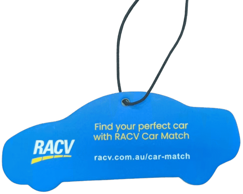 Blue custom car air freshener die-cut into the shape of a car, promoting 'RACV Car Match'. It features the RACV logo in white and yellow, and text 'Find your perfect car with RACV Car Match racv.com.au/car-match'. A black hanging string is attached.