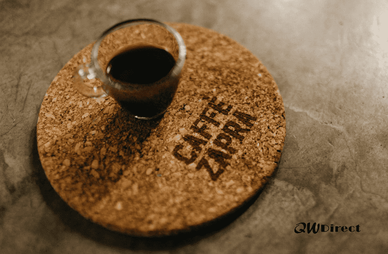 Circular cork drink coaster which has been custom branded with the words Caffe Zapra printed on it.