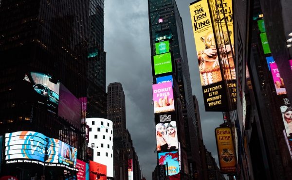 Numerous digital signage colourful displays on large city buildings.