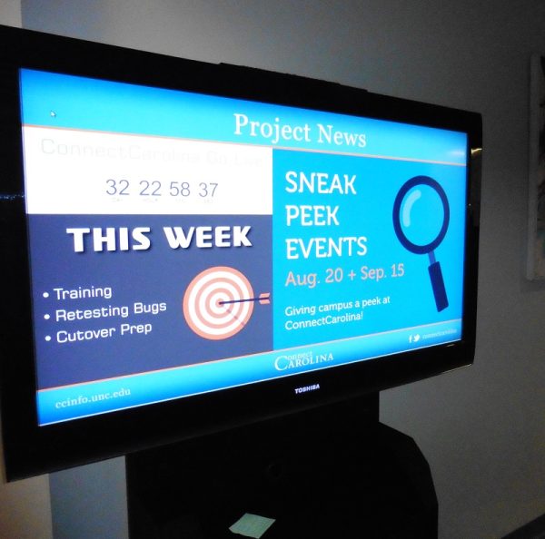 Project news update displayed on a digital signage screen.