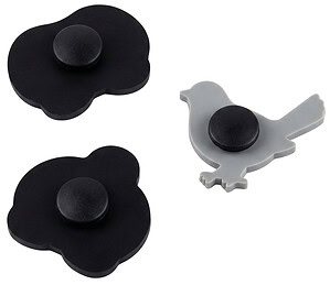 The back view of custom shoe charms showing the standard secure black button attachment mechanism designed to fit perfectly into the holes of Crocs and other clog footwear.