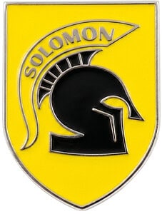 A vibrant yellow shield-shaped custom badge featuring a black Spartan-style helmet and "SOLOMON" text in raised silver metal.