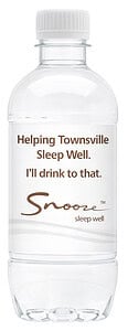 A custom branded spring water bottle for Snooze, featuring a professional white label with brown typography and brand logos.