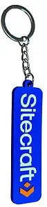 A custom blue rubber keyring for Sitecraft with raised white 2D text and orange logo, on a white background.